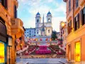 Scalinata di Trinità dei Monti a Roma, un luogo iconico per i tuoi prossimi viaggi da fare, con fiori colorati e un'atmosfera magica.