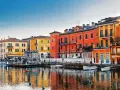 Colorate case affacciate sull'acqua, un incantevole scorcio di una delle tante città da visitare nel nord Italia.