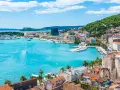 Splendido panorama di Spalato: cosa vedere nel porto turistico, la città con i suoi edifici storici e la collina verdeggiante.