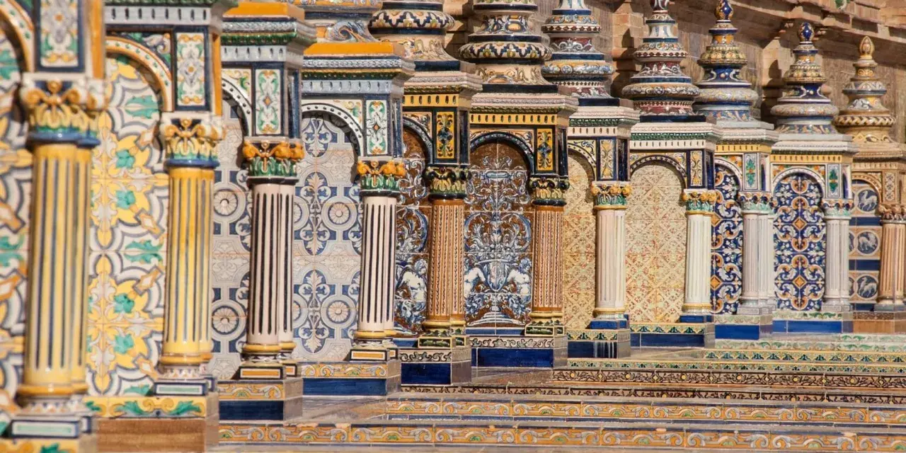 Ornate tiled columns and arches in Seville, Spain.