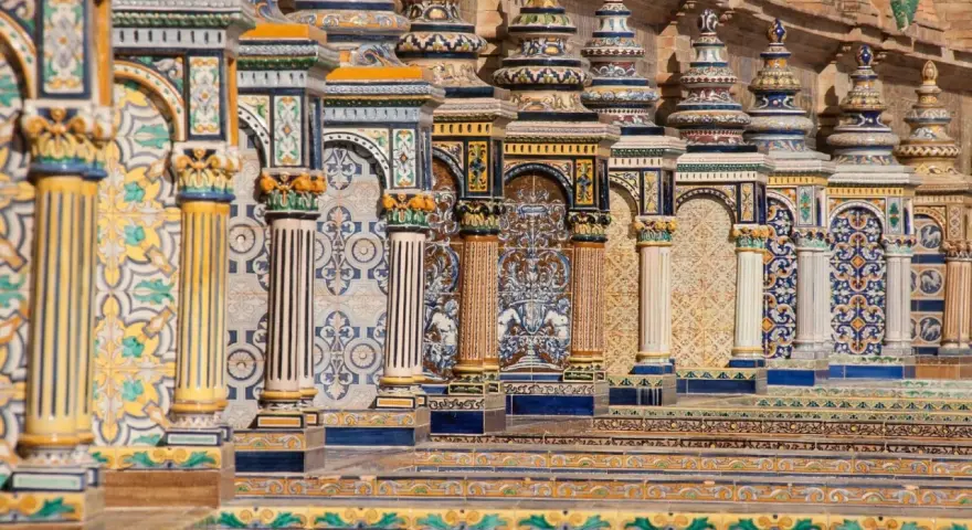 Ornate tiled columns and arches in Seville, Spain.