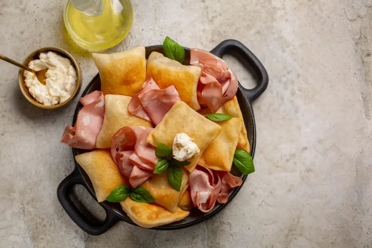 Fritti quadrati con mortadella e formaggio cremoso, un'idea sfiziosa su cosa mangiare a Bologna.